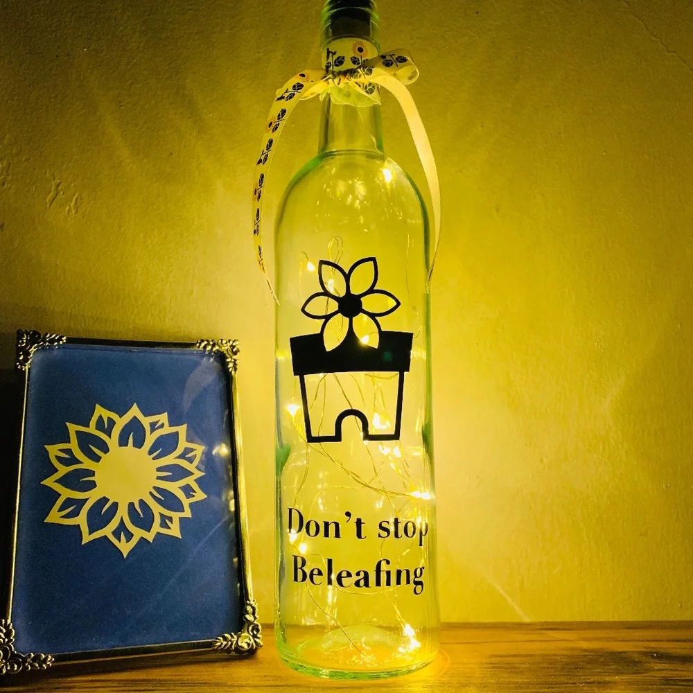 ‘Don’t Stop Beleafing’ logo wine bottle lantern